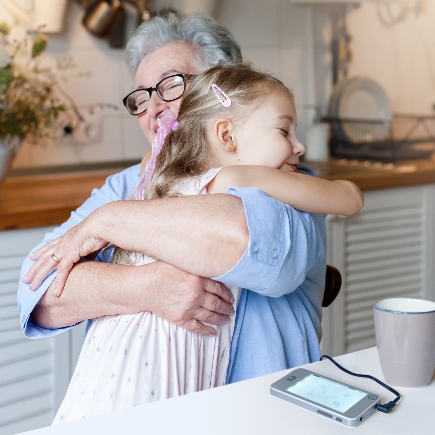 Child Hugging granny, grandmother using nurokor Lifetech device for pain