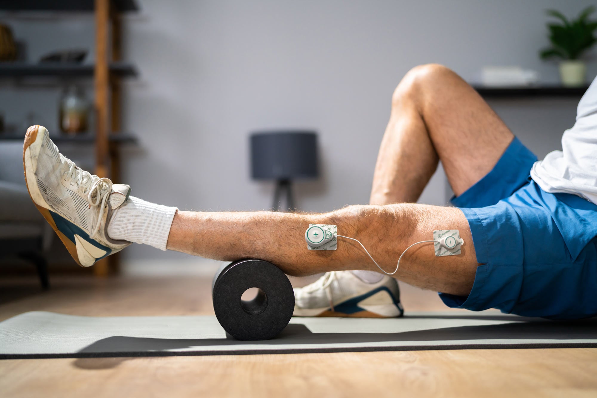 NuroKor mibody device on leg for recovery from injury, pain relief, wellness and rehabilitation